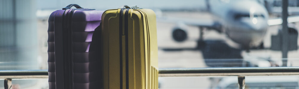 Suitcases,In,Airport,Departure,Lounge,,Airplane,In,Background,,Summer,Vacation